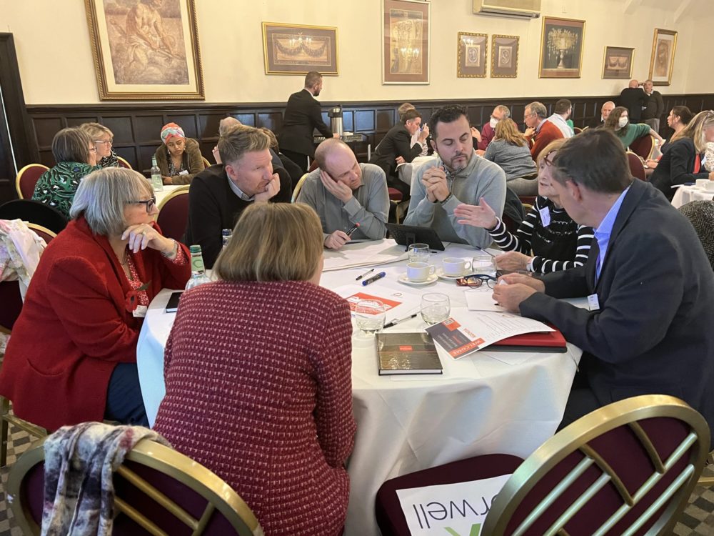 Independent East Conference November 2022, delegates discussing in group around a table