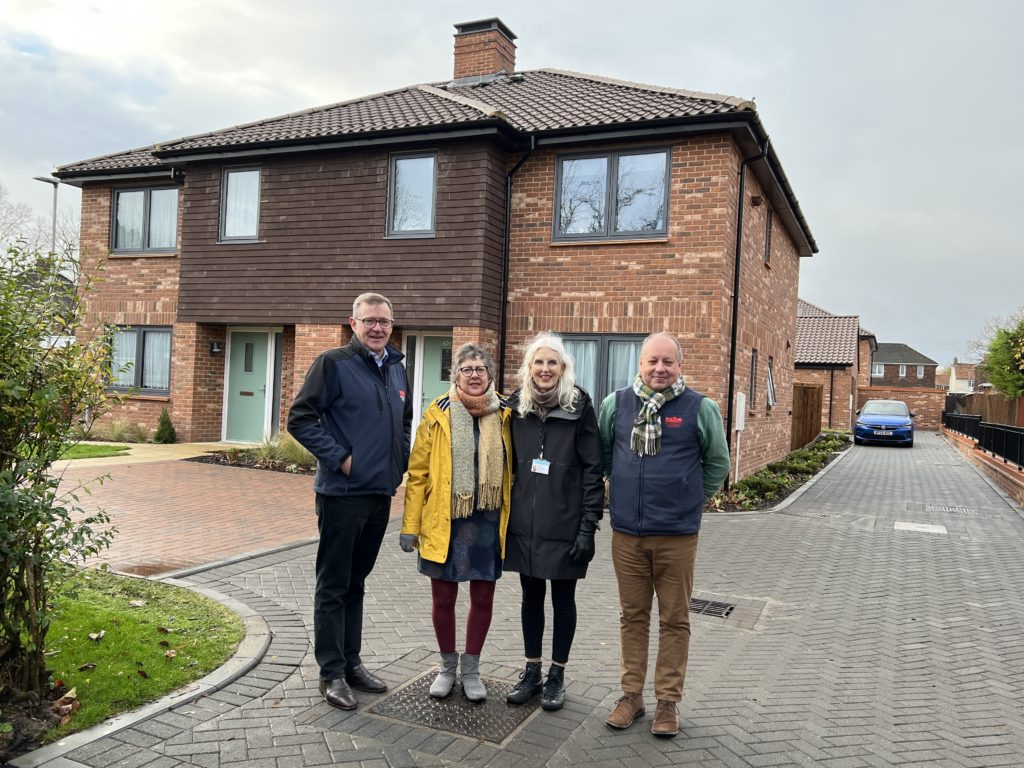 Michael Newey (Broadland Housing Association, Gail Harris (Norwich City Council) and Andrew Savage (Broadland Housing Association) outside the new social rent homes at Mile Cross Norwich